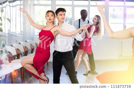 Young guy and adult woman dance tango 111873739