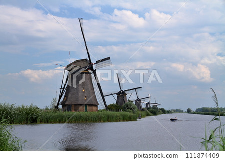 A group of windmills in Kinderdijk, a World Heritage Site, near Rotterdam, South Holland, in the Netherlands in Western Europe. 111874409