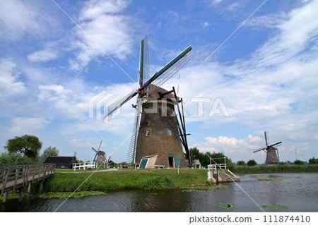A group of windmills in Kinderdijk, a World Heritage Site, near Rotterdam, South Holland, in the Netherlands in Western Europe. 111874410