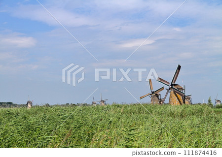 A group of windmills in Kinderdijk, a World Heritage Site, near Rotterdam, South Holland, in the Netherlands in Western Europe. A group of windmills in Kinderdijk, a World Heritage Site, near Rotterdam, South Holland, in the Netherlands in Western Europe. 111874416