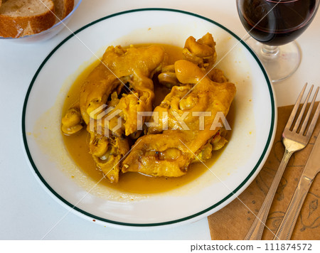 Portion of braised pig trotters with gravy Portion of braised pig trotters with gravy 111874572