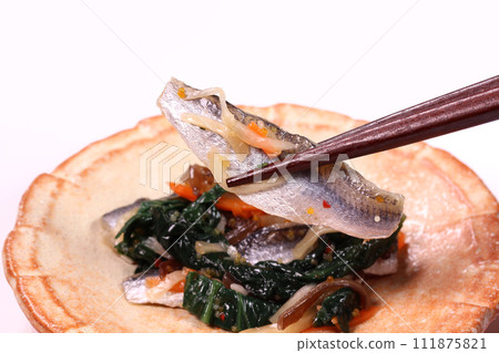 Eating pickled makari Eating pickled makari 111875821