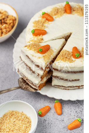 Homemade carrot cake made with walnuts, iced with cream cheese. Sweet dessert. Homemade carrot cake made with walnuts, iced with cream cheese. Sweet dessert. 111876193