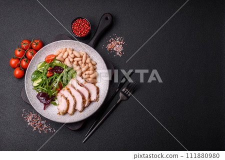 Delicious dietary salad with arugula, cucumber and cherry tomatoes and chicken breast slices Delicious dietary salad with arugula, cucumber and cherry tomatoes and chicken breast slices 111880980