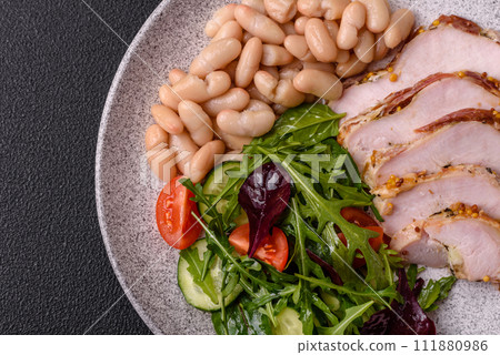 Delicious dietary salad with arugula, cucumber and cherry tomatoes and chicken breast slices 111880986