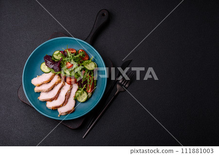 Delicious dietary salad with arugula, cucumber and cherry tomatoes and chicken breast slices Delicious dietary salad with arugula, cucumber and cherry tomatoes and chicken breast slices 111881003