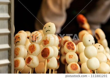 Skewered dumplings at a food stall with faces written on them Skewered dumplings at a food stall with faces written on them 111881201