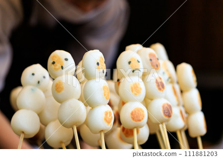 Skewered dumplings at a food stall with faces written on them Skewered dumplings at a food stall with faces written on them 111881203