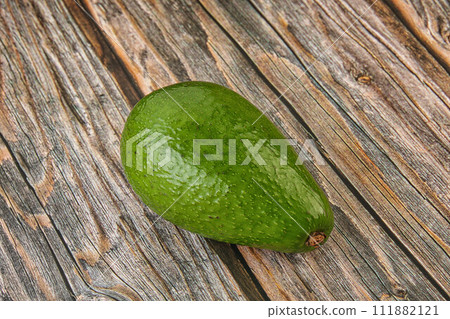 Ripe green avocado over background Ripe green avocado over background 111882121