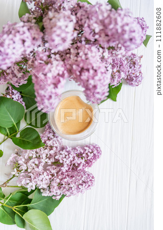 freshly brewed cup of coffee among vibrant lilac blossoms, capturing essence of tranquil spring morning freshly brewed cup of coffee among vibrant lilac blossoms, capturing essence of tranquil spring morning 111882608