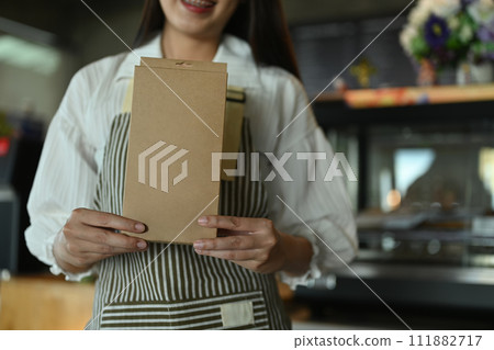 Small business entrepreneur holding brown package box, sustainable ecological business and craft product 111882717