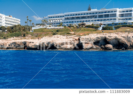 View of stone cliffs and hotels at Ayia Napa coastline . Famagusta district, Cyprus View of stone cliffs and hotels at Ayia Napa coastline . Famagusta district, Cyprus 111883009