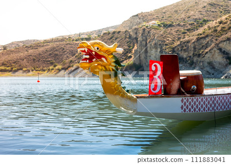 A brightly coloured Dragon Boat on the river A brightly coloured Dragon Boat on the river 111883041