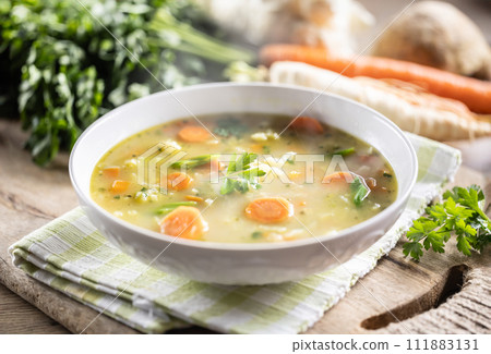 Spring vegetable soup with chopped and grated root vegetables, seasoned with yeast. Healthy vegetable vegetarian food Spring vegetable soup with chopped and grated root vegetables, seasoned with yeast. Healthy vegetable vegetarian food 111883131