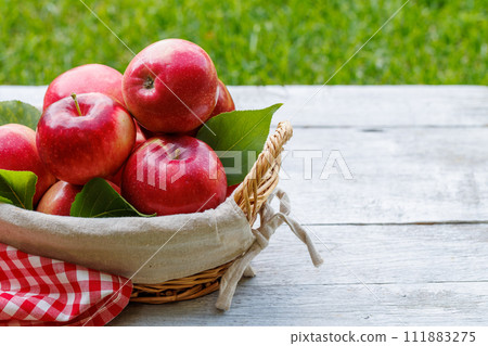 Basket with fresh red apples 111883275