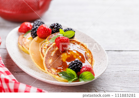 Tasty homemade pancakes with berries 111883281