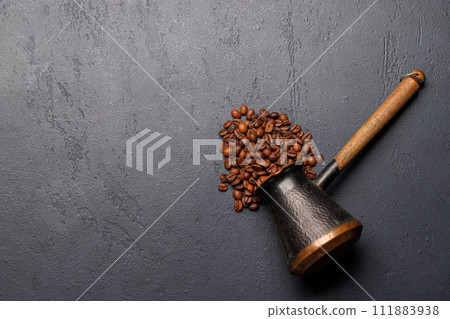 Roasted coffee beans and cezve for Turkish coffee 111883938