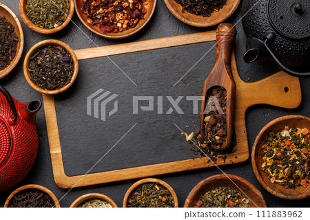 A collection of various teas nestled in wooden bowls 111883962