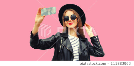 Portrait of beautiful young woman taking selfie with smartphone posing on pink background 111883963