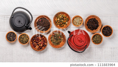A collection of various teas nestled in wooden bowls 111883964