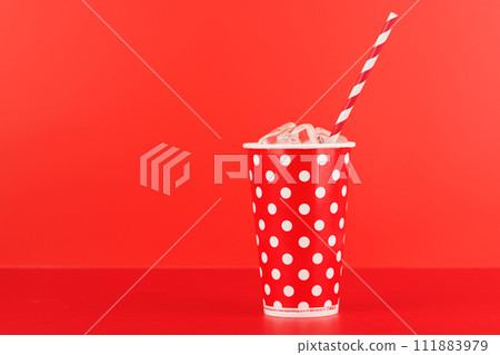 Paper cup with cola and ice over red background 111883979