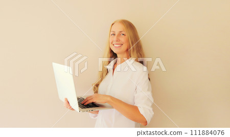 Happy caucasian middle-aged woman working with laptop at home Happy caucasian middle-aged woman working with laptop at home 111884076