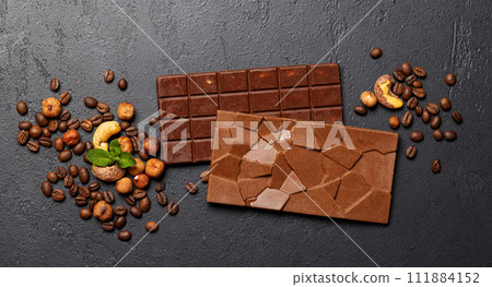 Two chocolate bars on stone background 111884152
