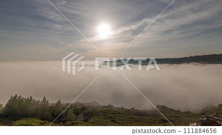 Panorama showing aerial View of Sesimbra Town and Port covered by fog timelapse, Portugal. 111884656