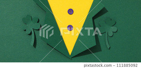 Clover leaves and paper suit on green background, space for text 111885092