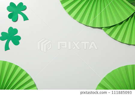 Paper decorations and clover leaves on white background, space for text 111885093