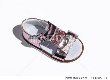 Side upper view of pink suede girl sandal, and velcros, isolated on white 111885181