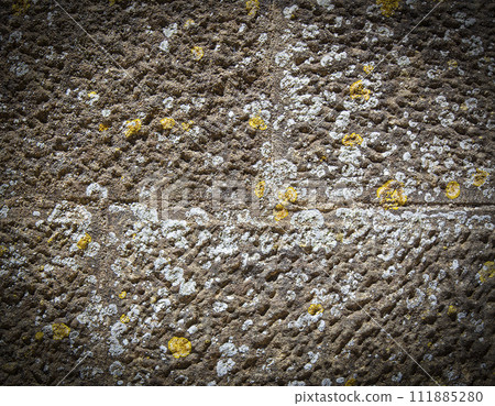 Old natural stone covered with black lichen and moss. Stone texture 111885280