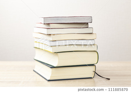 books piled on the desk 111885870