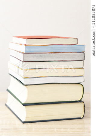 books piled on the desk 111885872