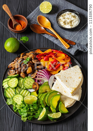 vegan fajitas with mushrooms, veggies on a plate 111886790