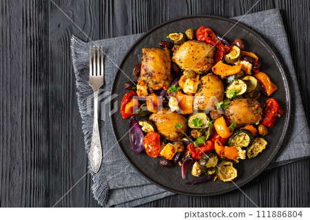 baked chicken thighs with veggies, olives, feta 111886804