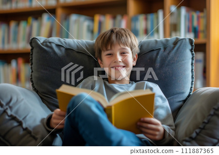 AI-generated content. Book day - child reads a book in comfortable chair in the library 111887365