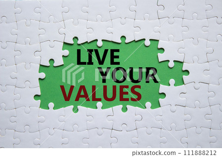 Live your values symbol. Concept words Live your values on white puzzle. Beautiful green background. Business and Live your values concept. Copy space. Live your values symbol. Concept words Live your values on white puzzle. Beautiful green background. Business and Live your values concept. Copy space. 111888212