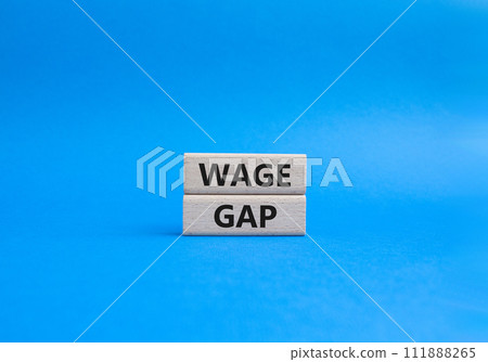 Wage Gap symbol. Concept words Wage Gap on wooden blocks. Beautiful blue background. Business and Wage Gap concept. Copy space. Wage Gap symbol. Concept words Wage Gap on wooden blocks. Beautiful blue background. Business and Wage Gap concept. Copy space. 111888265