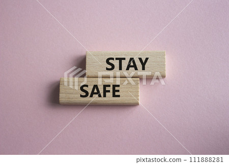Stay Safe symbol. Concept word Stay Safe on wooden blocks. Beautiful pink background. Business and Stay Safe concept. Copy space Stay Safe symbol. Concept word Stay Safe on wooden blocks. Beautiful pink background. Business and Stay Safe concept. Copy space 111888281