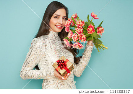 Woman hold bouquet of flowers and golden gift box Woman hold bouquet of flowers and golden gift box 111888357