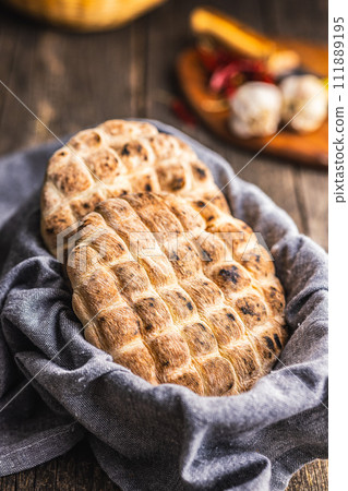 Arabic flat pita bread on wooden table. 111889195