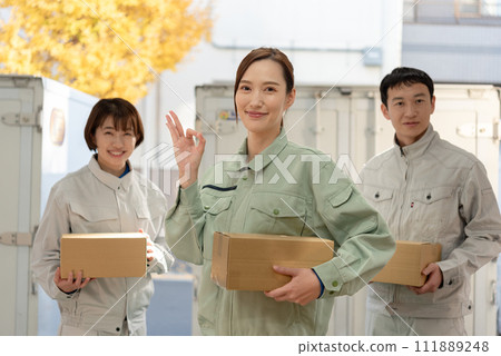 Men and women in work clothes carrying luggage 111889248