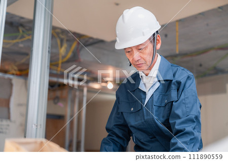 A carpenter working at a workbench 111890559