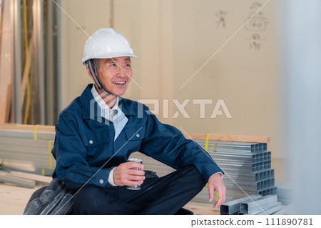 A carpenter taking a break at the job site 111890781