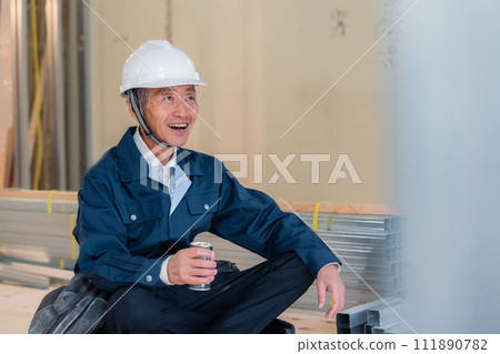 A carpenter taking a break at the job site A carpenter taking a break at the job site 111890782