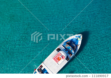 Top view of a yacht in clear blue sea 111890917