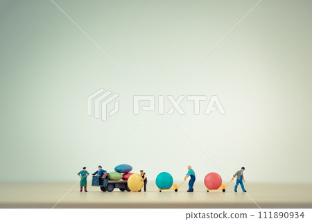 Workers unloading sugar coated chocolate candies from truck 111890934
