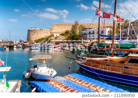 Boats moored in Kyrenia (Girne) harbour with fortress on background Boats moored in Kyrenia (Girne) harbour with fortress on background 111890950