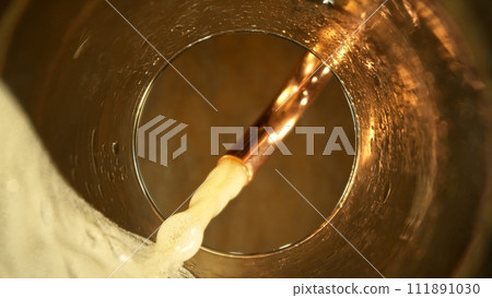 Macro Shot of Beer Pouring into Glass. 111891030